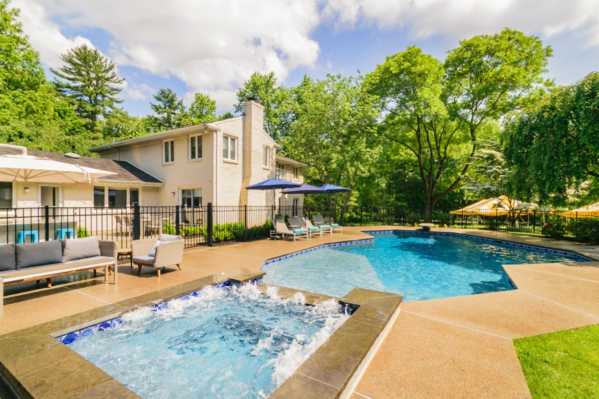 pool with tanning ledge, raised spa, diving board and fire pit