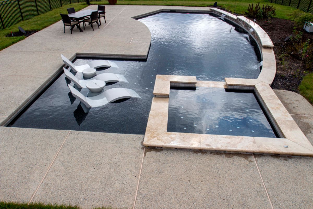 modern stone pool area with hot tub